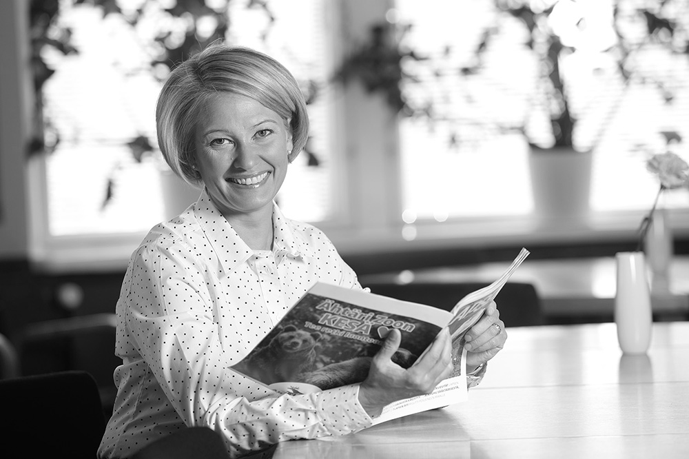 Ulla Siimes lukee Lapsen Maailma -lehteä hymyillen